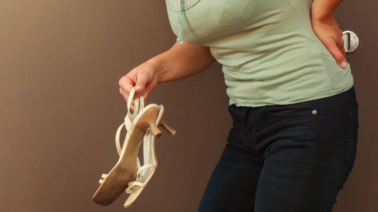 woman with back pain from high heels