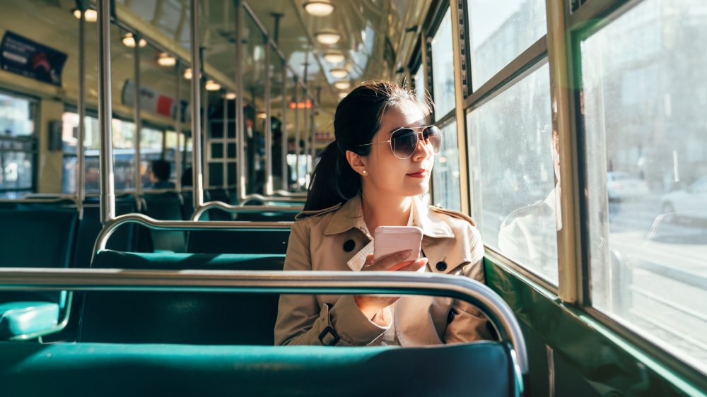 Woman riding public transportation.