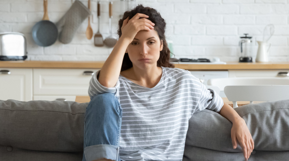 A woman sitting with headache