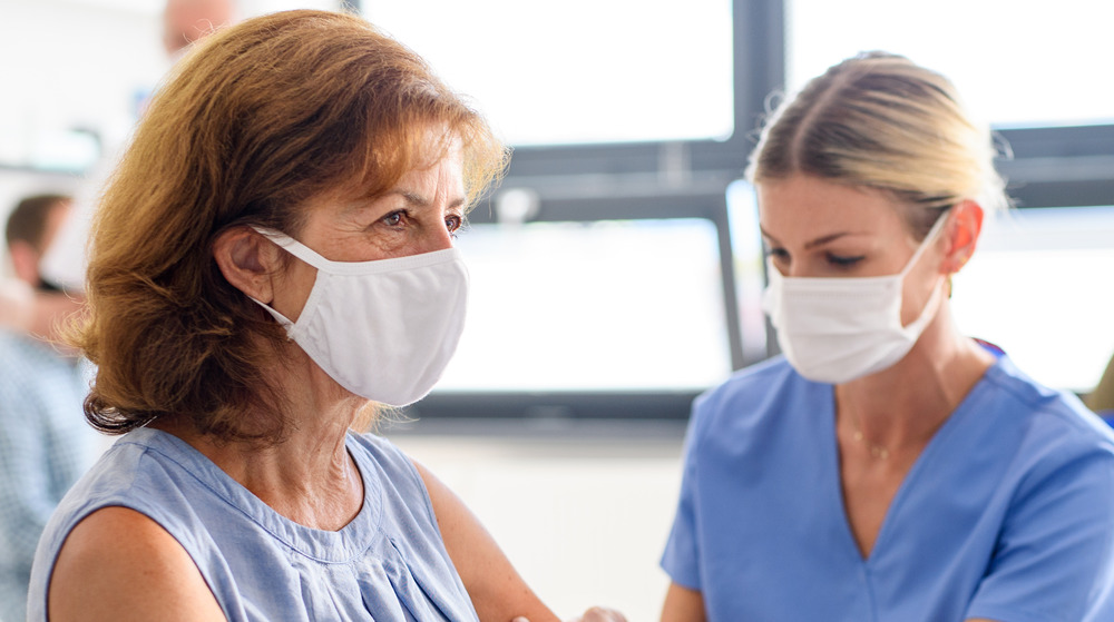 A doctor vaccinating a woman