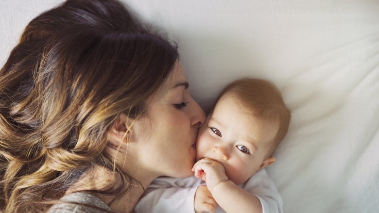 mom kissing baby