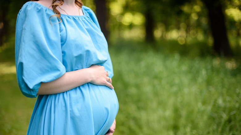 pregnant woman holding belly