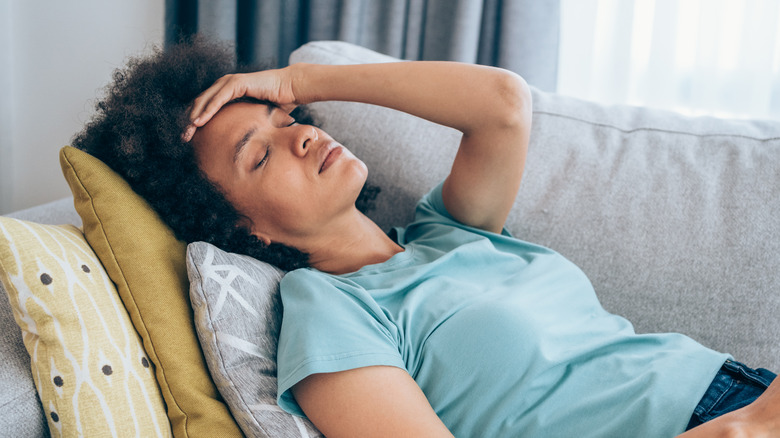 Woman with hand on her forehead