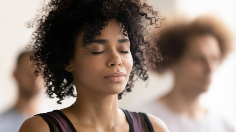 Woman workout class eyes closed