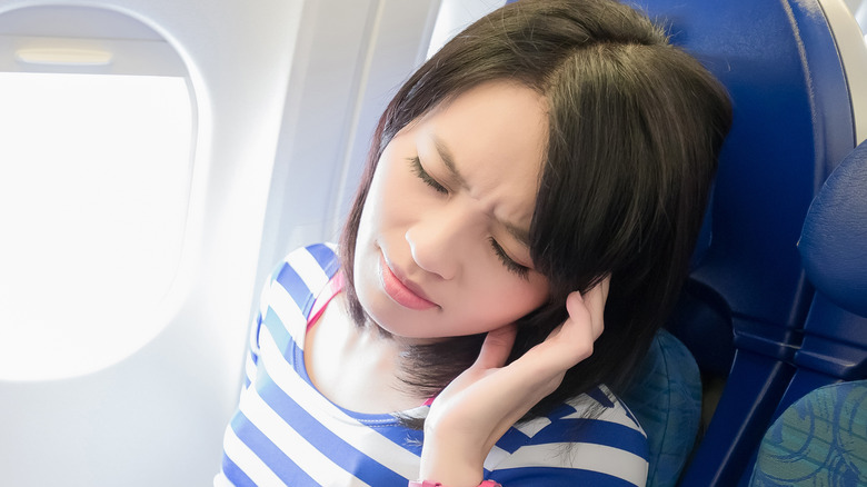 Woman with headache flying