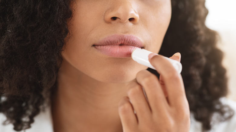 Woman applying chapstick