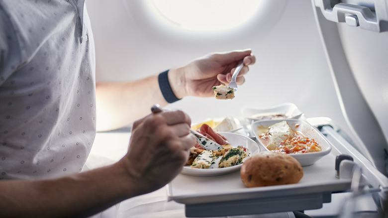 Man eating airplane food