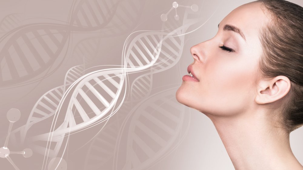 A woman' face over a background with a double helix