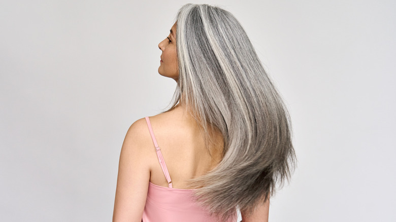 Gray-haired woman swaying hair