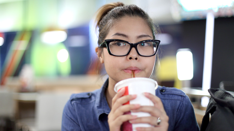 Woman drinking too much soda