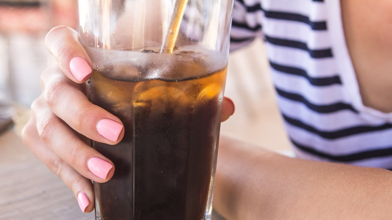 woman holding soda