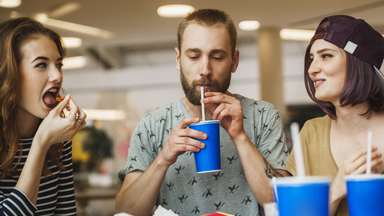 friend eating and drinking too much soda