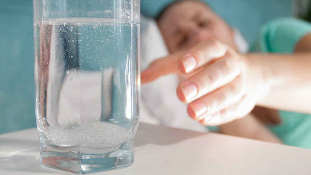 woman reaching for water