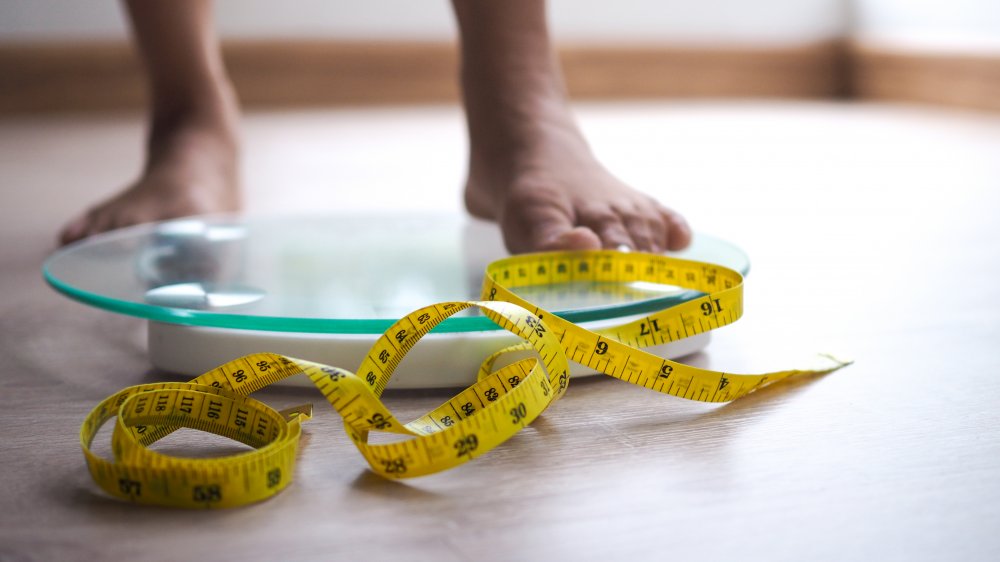 woman stepping on scale