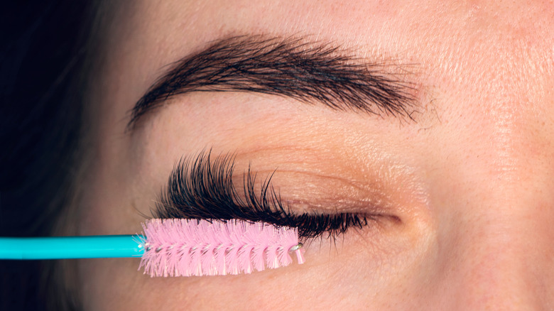 Woman applying mascara