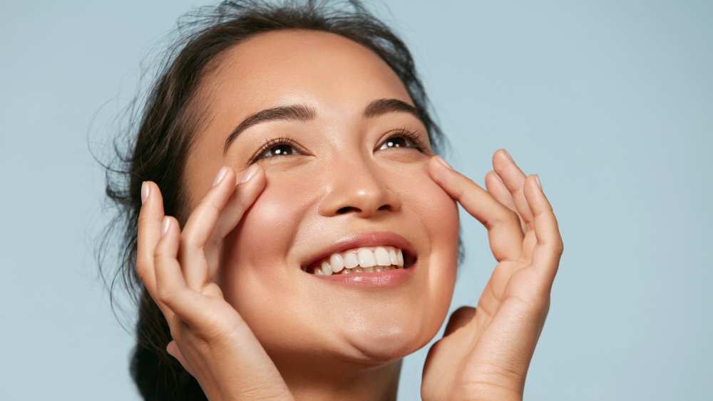 Woman touching her face