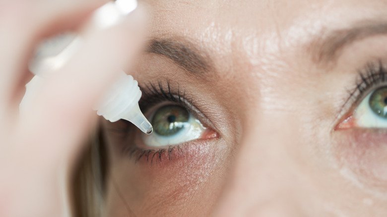 woman applying eye drops