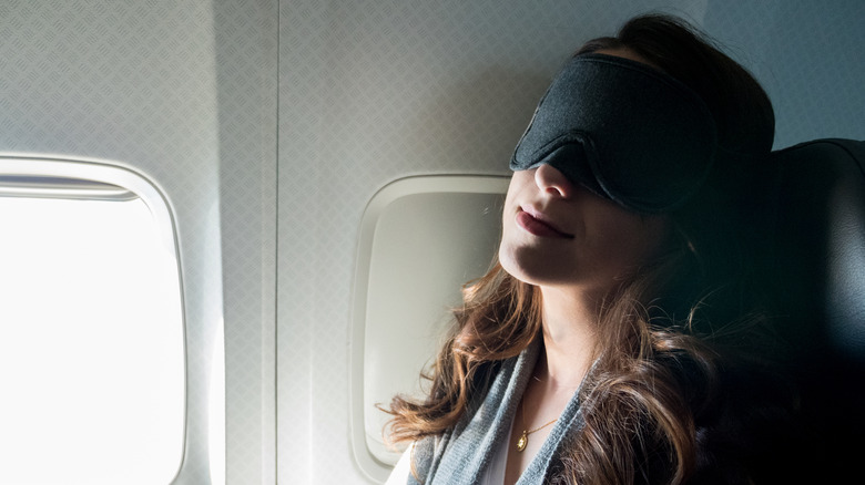 Woman on plane in eye mask