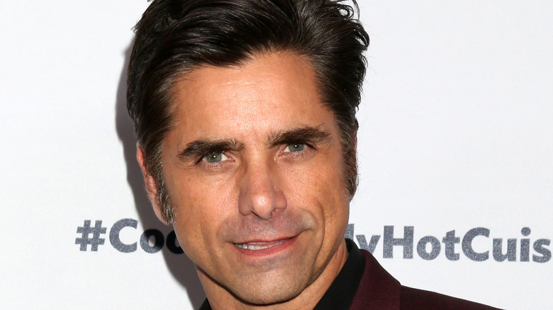 John Stamos poses for a photo. 