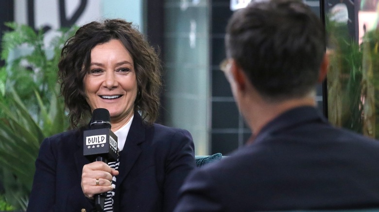 Sara Gilbert holding a microphone