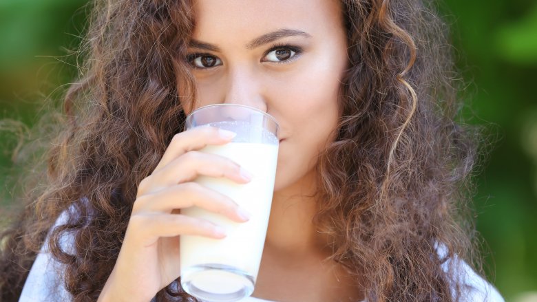 woman drinking a glass of milk