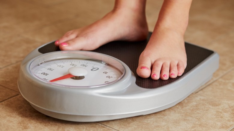 woman on scale weight diet