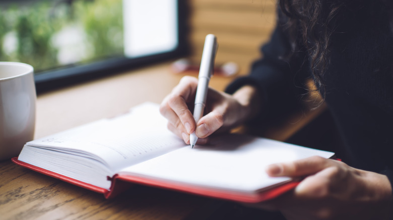 woman writing in journal