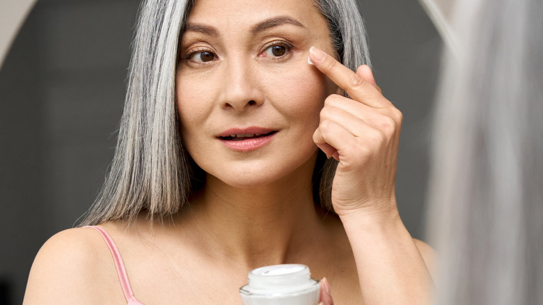 woman using eye cream