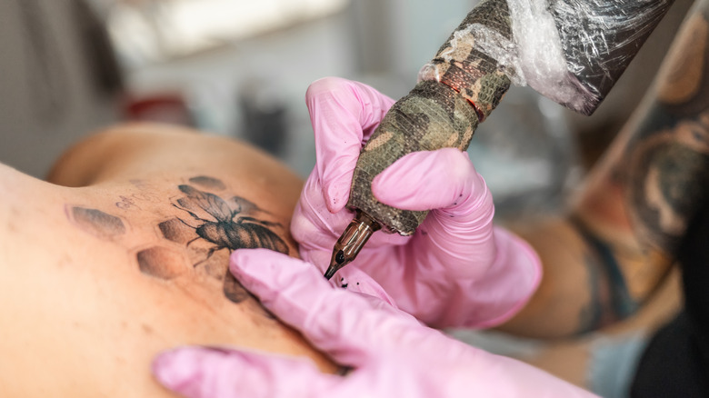 Person getting a bee tattoo