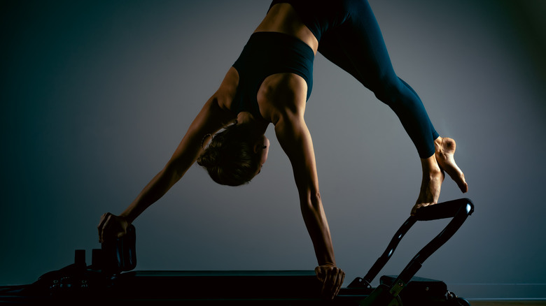 Woman doing Pilates with a reformer 