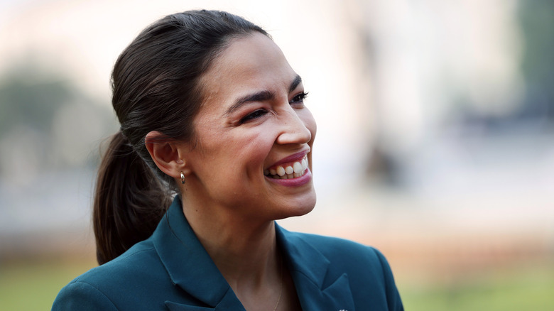 Alexandria Ocasio-Cortez smiling and looking off camera