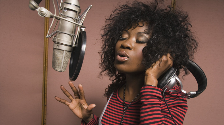 Woman singing in recording booth