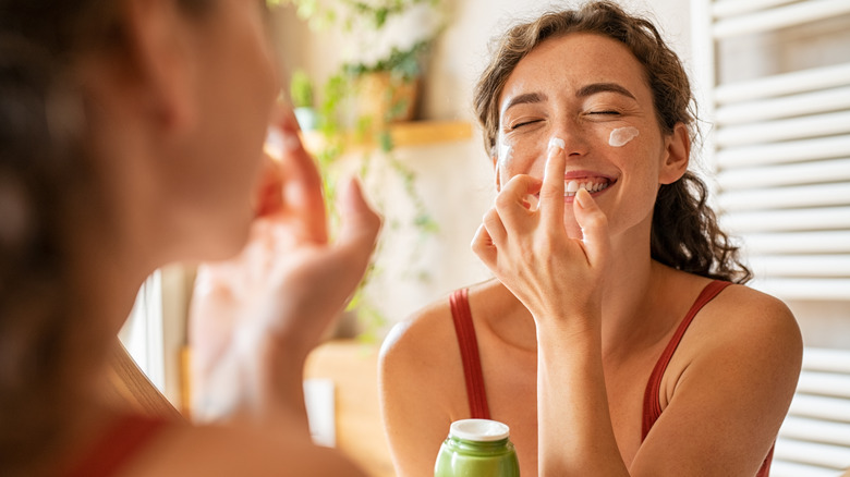 woman doing skincare, woman using moisturizer