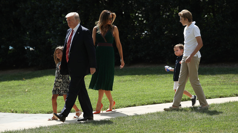 Barron Trump walking with Joseph Kushner, Melania Trump, Donald Trump, and Arabella Trump on the White House lawn