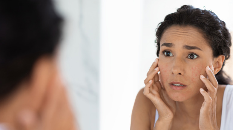 woman looking in the mirror