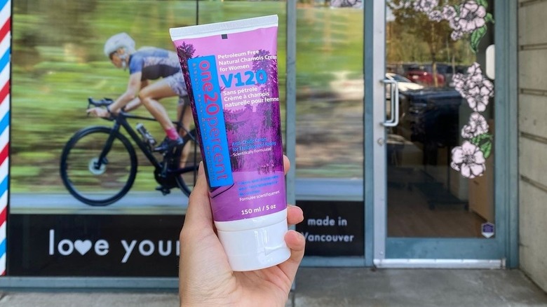 Hand holding a tube of chamois cream for women