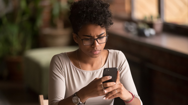 woman looking at phone