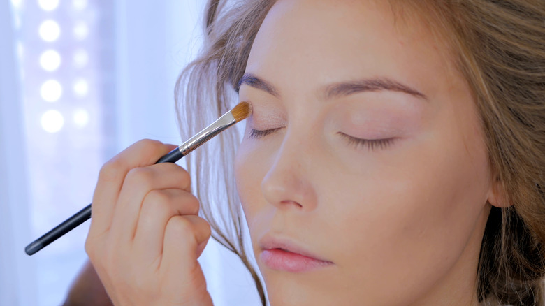 woman applying eyeshadow primer