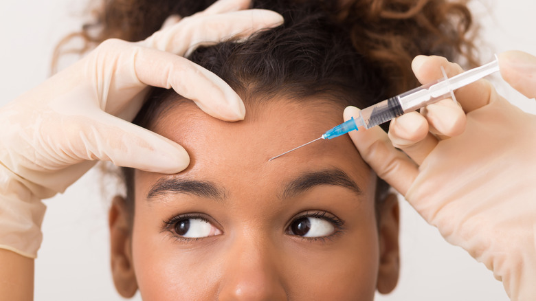 Woman watching her filler injector 