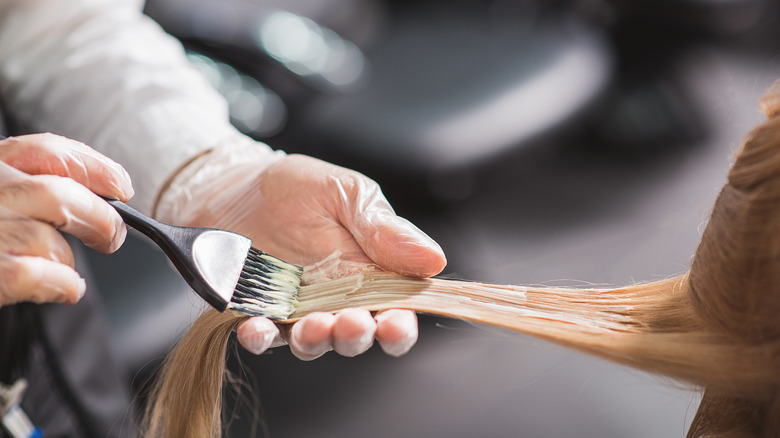 woman getting hair dyed