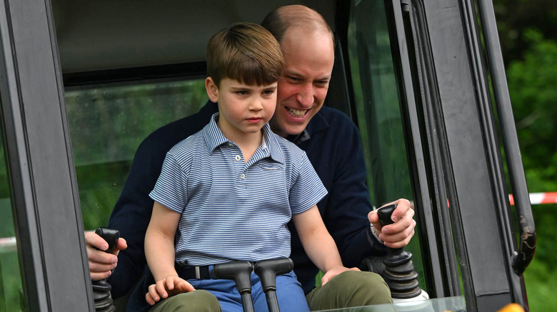 Prince William and Prince Louis operating a digger