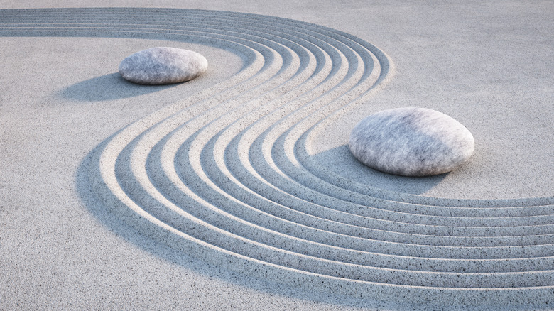  large stones in sand with wavy pattern