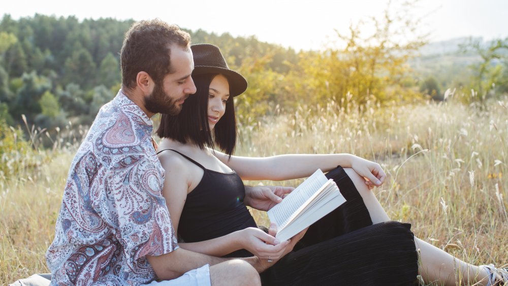 couple reading in a tech-free field