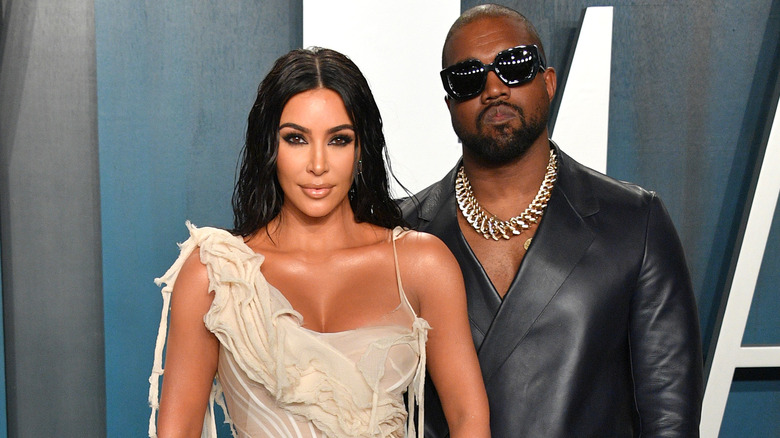 Kim Kardashian and Kanye West posing for photos