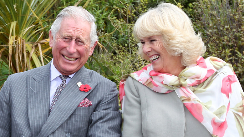 King Charles and Queen Camilla laughing