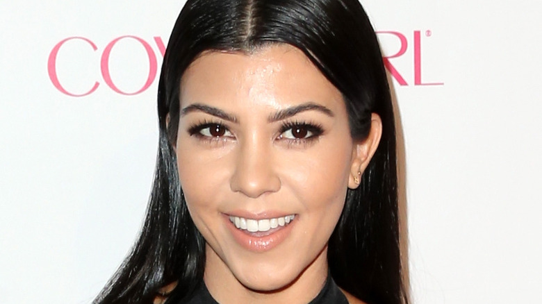 Kourtney Kardashian smiling on red carpet