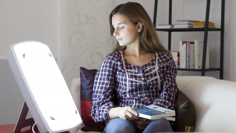 woman sitting in front of a light box