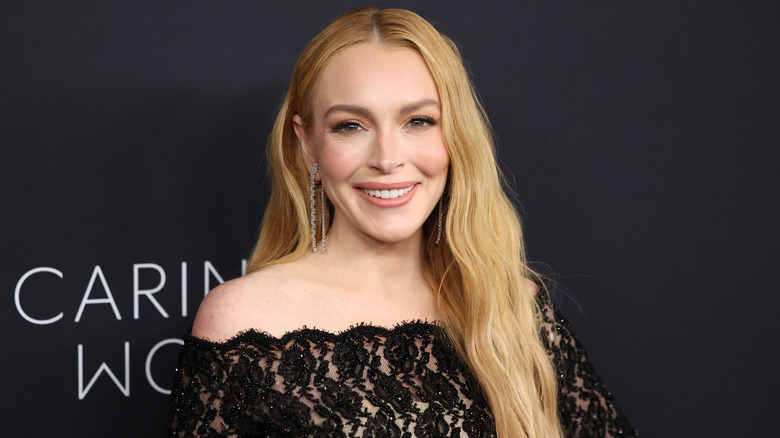 Lindsay Lohan smiling while attending the 2024 Kering Dinner in NYC