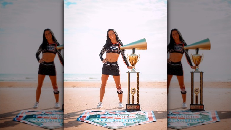 Maddy Brum posing with Navarro trophy in Daytona after the team's 15th win