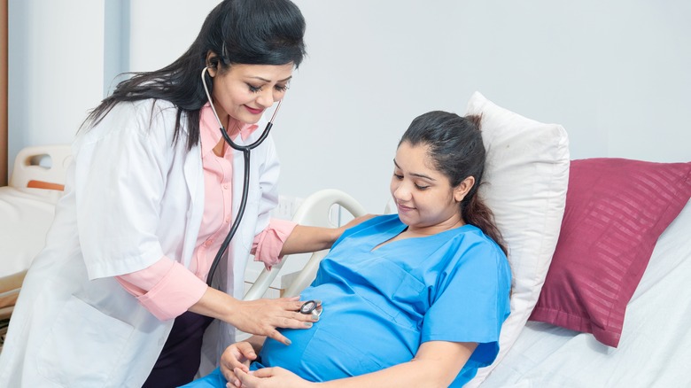 Pregnant woman with her doctor